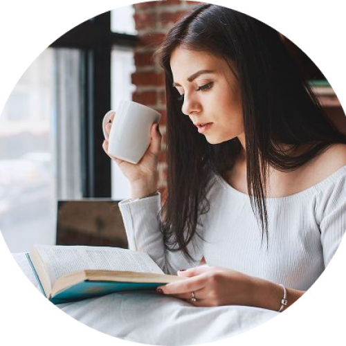 Book escape: a woman reading a book with a cup of tea